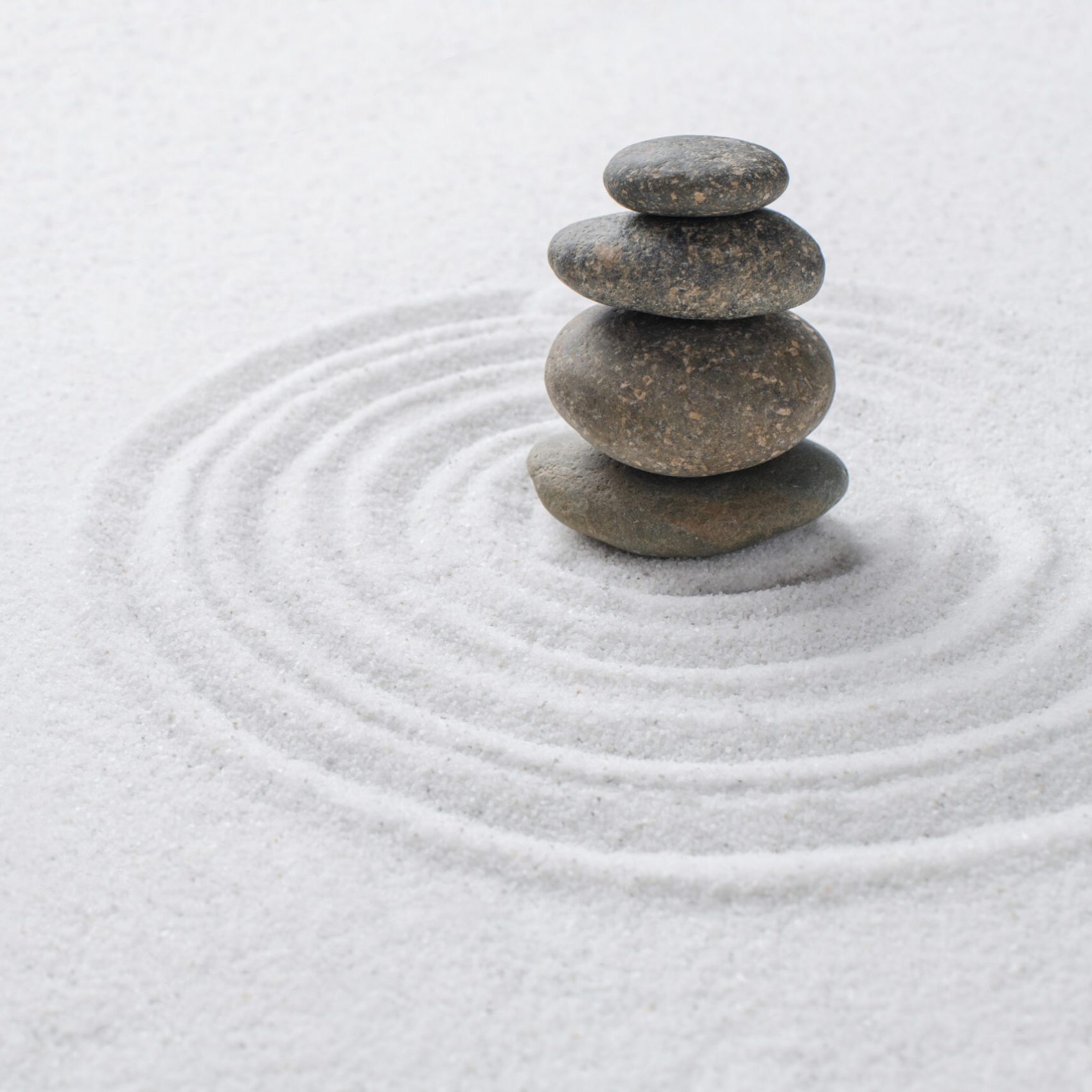 Stacked zen stones sand background art of balance concept Stacked zen stones sand background art of balance concept