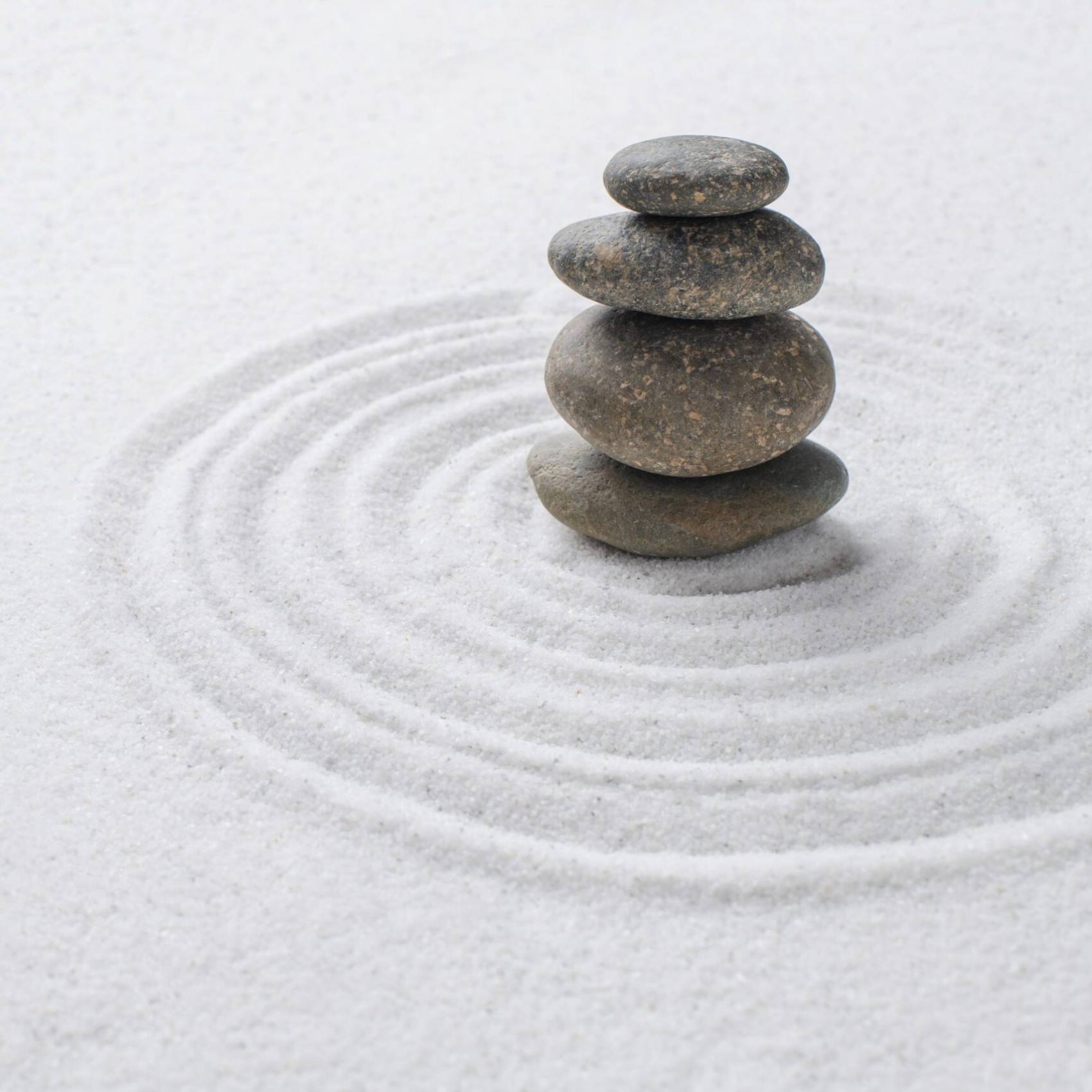 Stacked zen stones sand background art of balance concept Stacked zen stones sand background art of balance concept